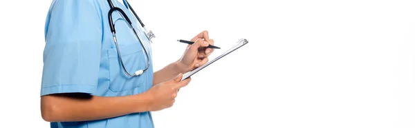 Cropped view of african american nurse writing on clipboard and smiling isolated on white, panoramic shot — Stock Photo