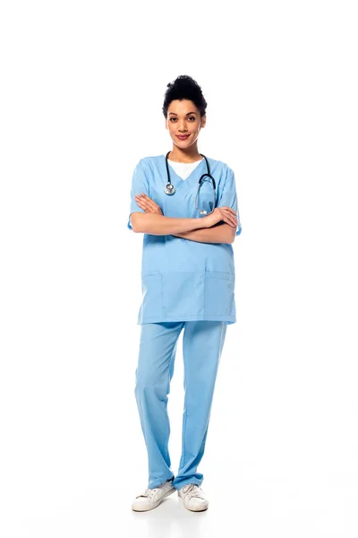 Front view of african american nurse with crossed arms smiling on white — Stock Photo