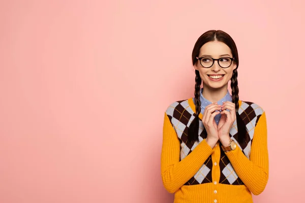 Cunning female nerd in eyeglasses gesturing on pink — Stock Photo