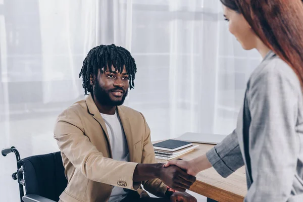 Disabled african american employee and recruiter shaking hands and looking at each other at job interview — Stock Photo
