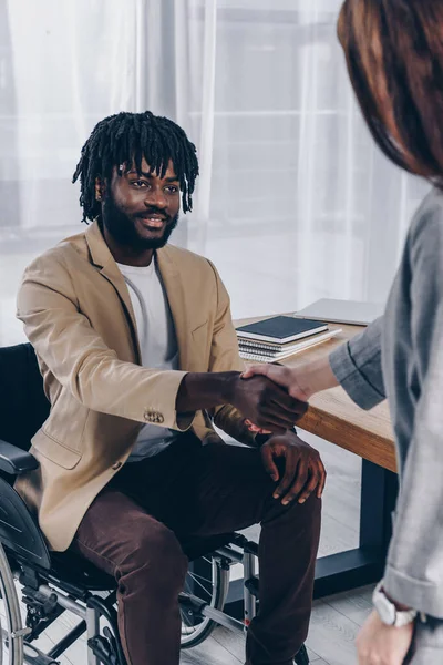 Disabled african american employee and recruiter shaking hands at job interview — Stock Photo