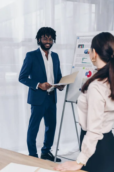 Selective focus of recruiters looking at each other and smiling in office — Stock Photo
