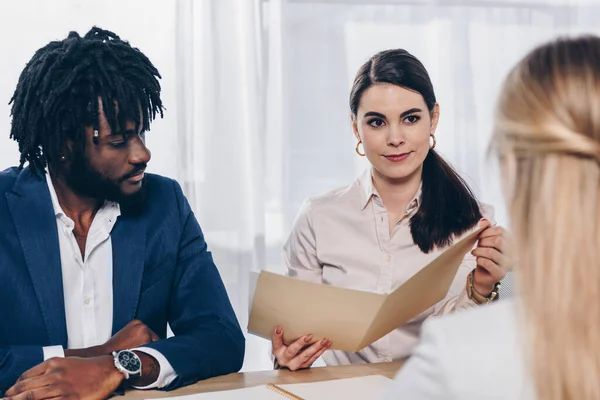Selective focus of multicultural recruiters conducting job interview with employee in office — Stock Photo