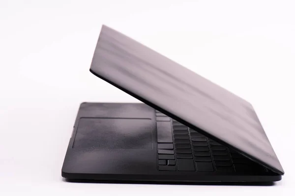 Black and modern laptop on white with copy space — Stock Photo