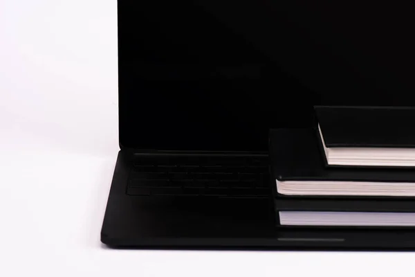 Notebooks on modern laptop with blank screen on white — Stock Photo
