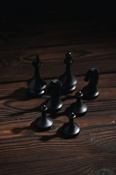 Black chess figures on textured surface — Stock Photo