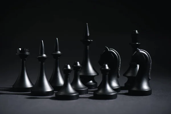 Selective focus of chess figures on black — Stock Photo