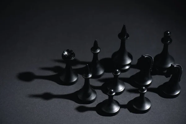 Selective focus of chess figures on black with copy space — Stock Photo