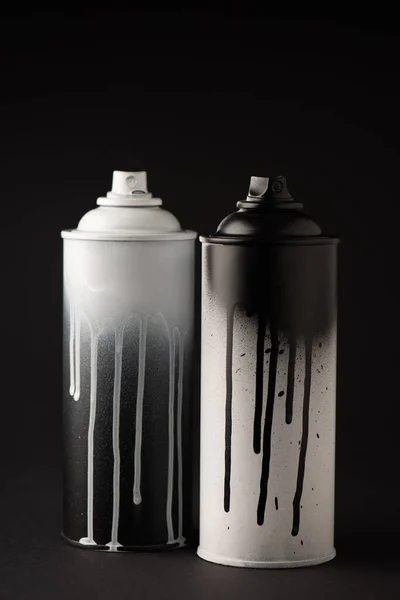 Graffiti paint cans on black with copy space — Stock Photo