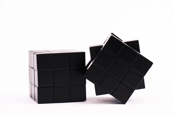 KYIV, UKRAINE - FEBRUARY 21, 2020: black rubik cubes on white — Stock Photo