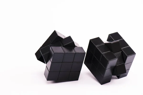 KYIV, UKRAINE - FEBRUARY 21, 2020: black rubik cubes for strategy game on white with copy space — Stock Photo