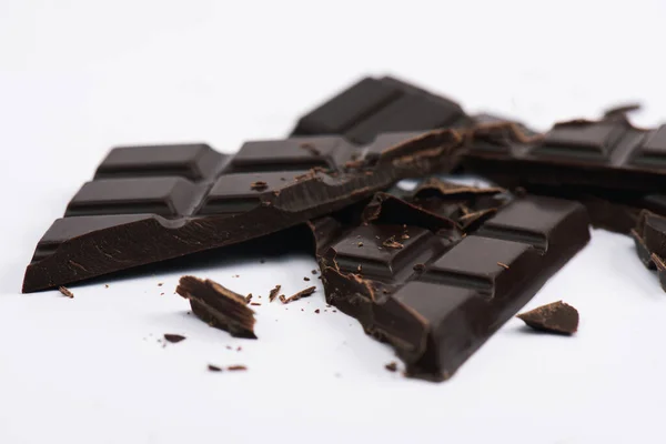 Selective focus of cracked and sweet chocolate on white — Stock Photo