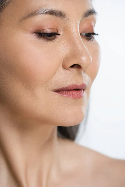 Close up of adult asian naked woman with perfect skin and grey hair isolated on grey — Stock Photo