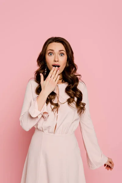 Shocked girl covering mouth isolated on pink — Stock Photo