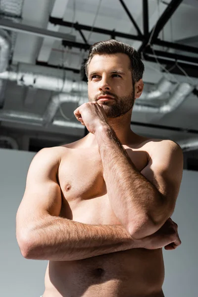 Low angle view of pensive and shirtless man — Stock Photo