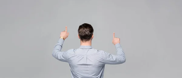 Panoramic shot of businessman pointing with fingers isolated on grey — Stock Photo