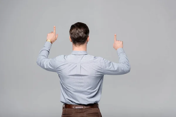 Back view of businessman pointing with fingers isolated on grey — Stock Photo