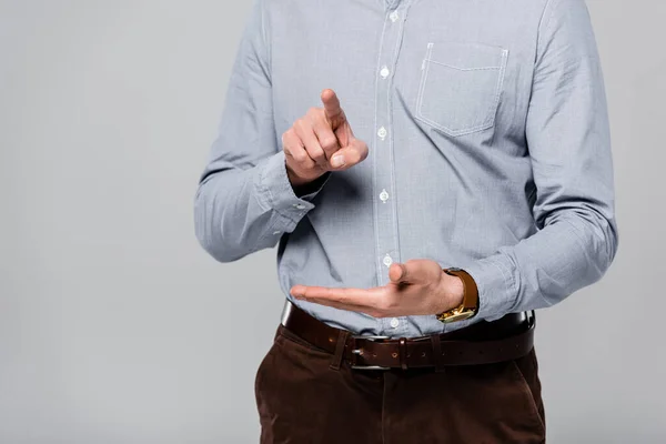 Vista recortada del hombre de negocios señalando con el dedo aislado en gris - foto de stock