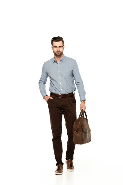 Handsome and bearded businessman holding bag and standing with hand in pocket  isolated on white — Stock Photo