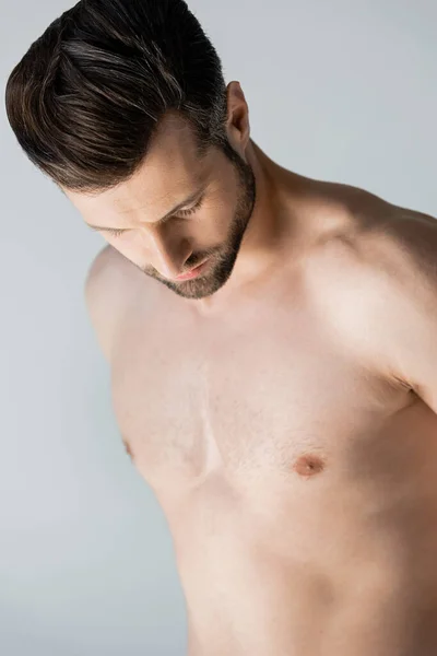 Muscular and shirtless man standing isolated on grey — Stock Photo