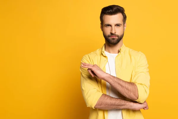 Hombre guapo mostrando gesto en lenguaje sordo y mudo sobre fondo amarillo - foto de stock