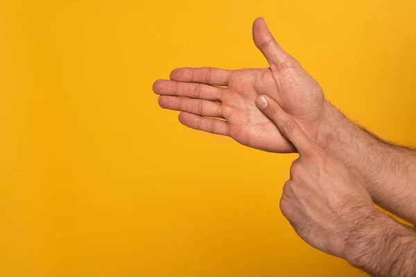 Cropped view of male hands showing gesture in deaf and dumb language isolated on yellow — Stock Photo