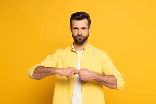 Man looking at camera while showing word friend in deaf and dumb language on yellow background — Stock Photo