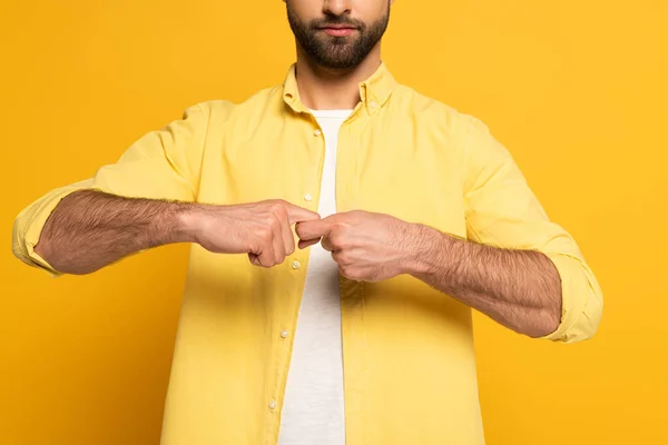 Cropped view of man showing word friend in deaf and dumb language on yellow background — Stock Photo