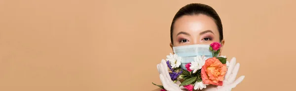 Panoramic shot of asian girl in latex gloves and floral face mask isolated on beige — Stock Photo
