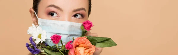 Panoramic shot of beautiful asian girl in floral face mask isolated on beige — Stock Photo
