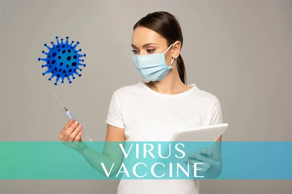 Girl in medical mask holding syringe and digital tablet isolated on grey, virus vaccine illustration — Stock Photo