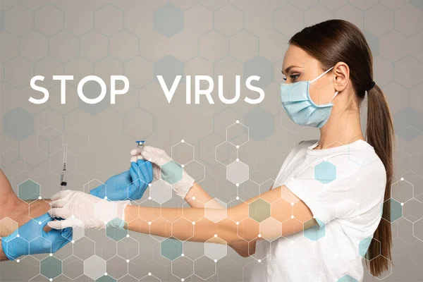 Side view of woman taking jar of vaccine and syringe from man in latex gloves isolated on grey, stop virus illustration — Stock Photo