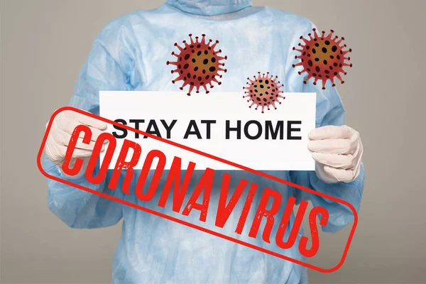 Cropped view of doctor in latex gloves holding card with stay at home lettering isolated on grey, coronavirus and bacteria illustration — Stock Photo