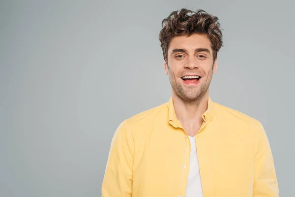 Front view of man smiling and looking at camera isolated on grey — Stock Photo