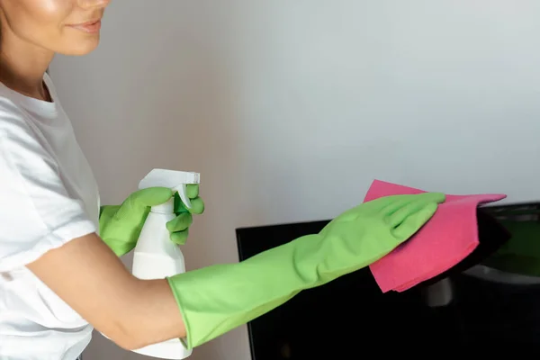 Cropped view of girl in latex gloves cleaning furniture with pink rag and spray bottle — Stock Photo