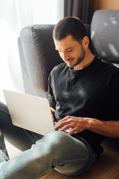 Cheerful and bearded freelancer using laptop at home — Stock Photo