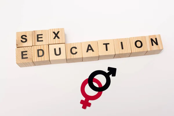 Top view of cubes with sex education lettering and gender symbols isolated on white — Stock Photo