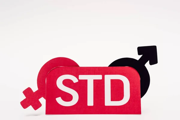 Gender symbols near paper with std lettering on white — Stock Photo