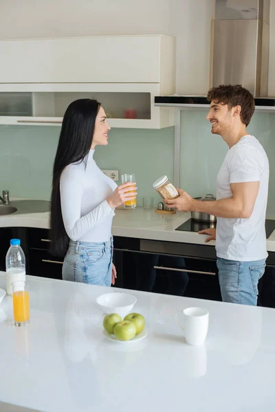 Cheerful couple making breakfast during self isolation at home — Stock Photo