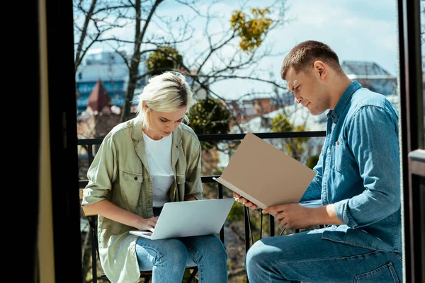 Business people working with laptop and papers on sunny terrace — Stock Photo