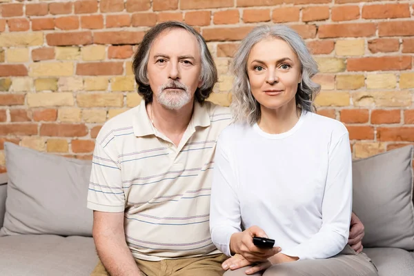 Pareja madura viendo la película en la sala de estar - foto de stock