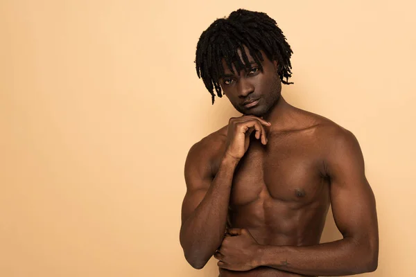 Handsome african american shirtless man on beige — Stock Photo