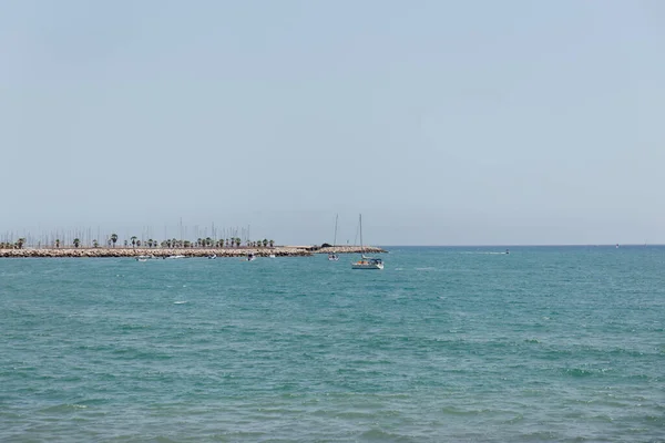 Yachts in sea near pier with blue sky at background in Catalonia, Spain — Stock Photo