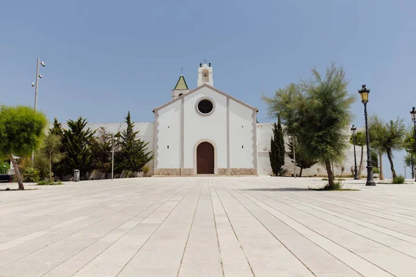 Vue en angle bas des arbres près de la chapelle avec ciel bleu en arrière-plan en Catalogne, Espagne — Photo de stock