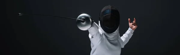 Panoramic orientation of fencer training with rapier isolated on black — Stock Photo