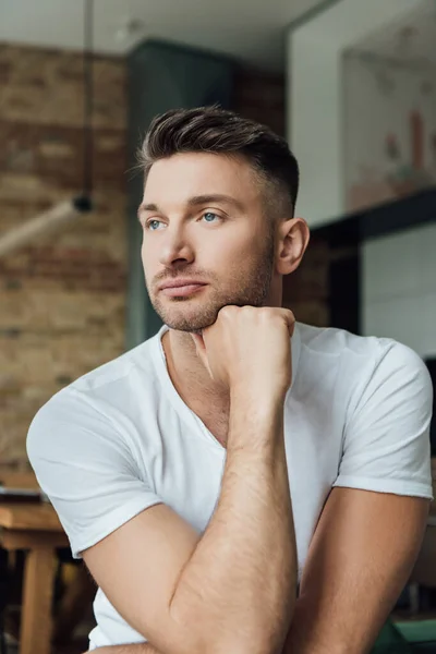 Selective focus of pensive man looking away in living room — Stock Photo