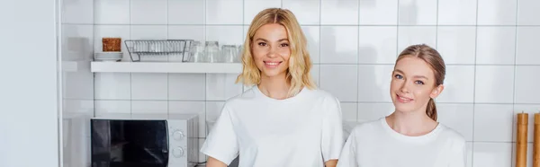 Horizontal concept of cheerful sisters looking at camera — Stock Photo