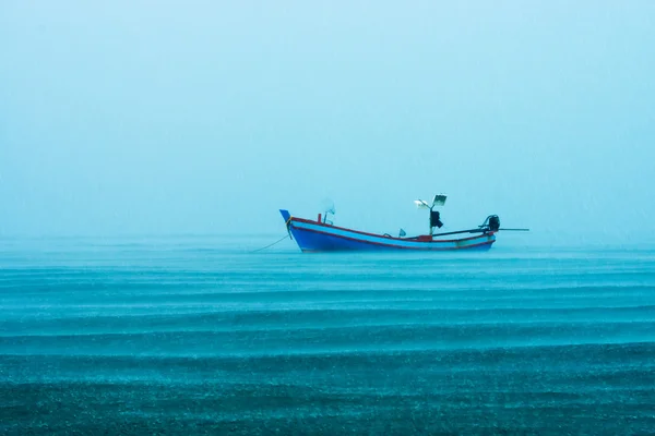 Barco de pesca no mar com chuva no mar . — Fotografia de Stock