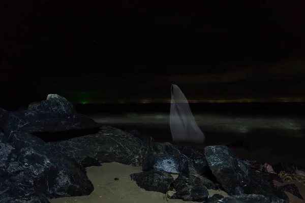 Image discrète un fantôme blanc flou sur la plage . — Photo
