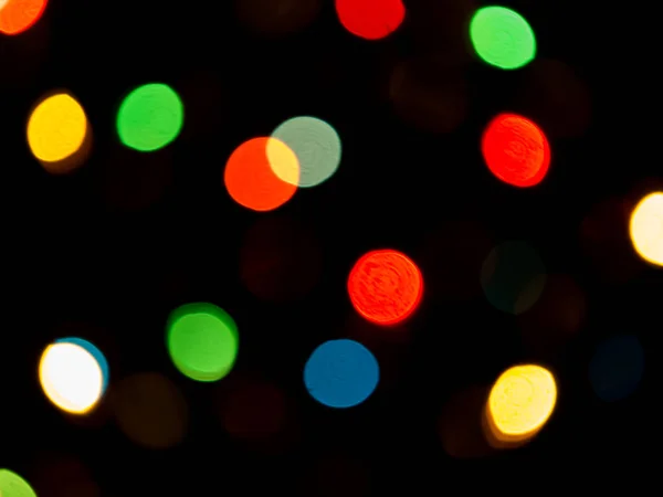 Lichte bokeh met een zwarte achtergrond. — Stockfoto